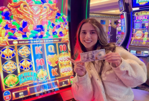 a lady holding money and sot games in the background showing startegies to maximize slot game winnings 