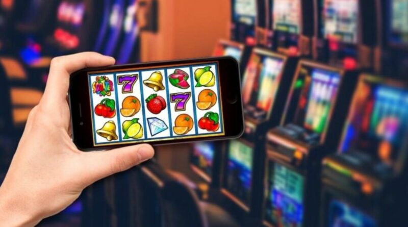 a hand holding a phone playing online slots